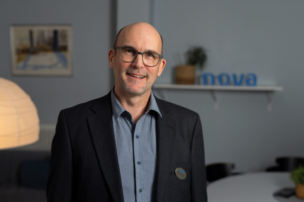 En man i kavaj som ler.